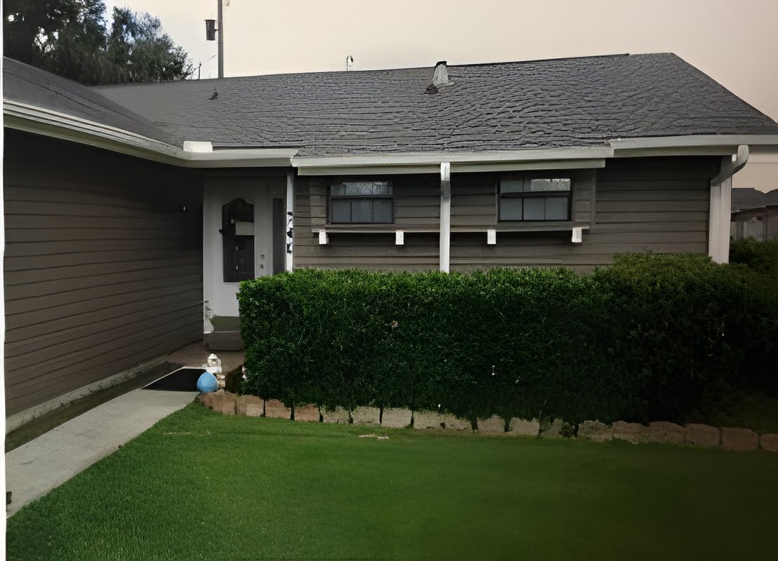 House with gray siding and a shingle roof